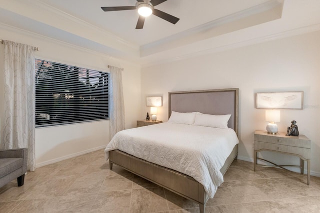 bedroom with baseboards, a raised ceiling, and crown molding