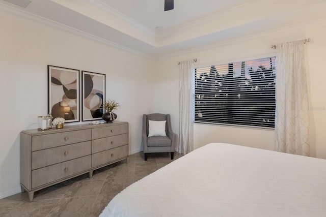 tiled bedroom featuring a ceiling fan, a raised ceiling, crown molding, and baseboards