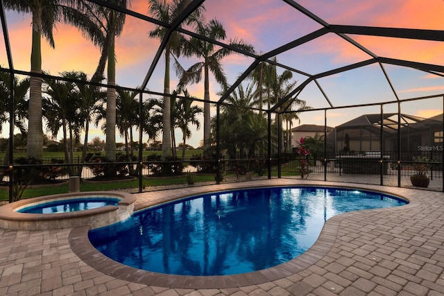 view of swimming pool with a lanai, a patio area, and a pool with connected hot tub