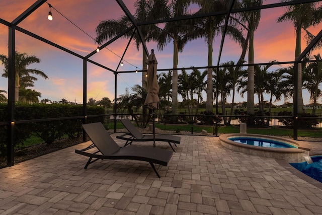 view of swimming pool featuring a patio area, a lanai, and a pool with connected hot tub