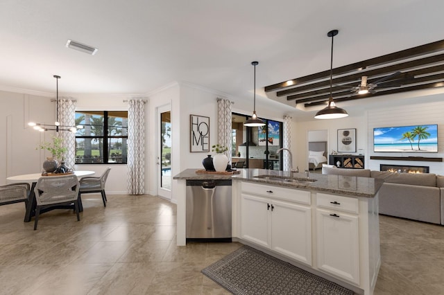 kitchen with open floor plan, beamed ceiling, stainless steel dishwasher, stone counters, and a sink