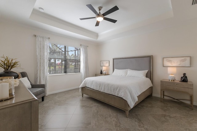 bedroom with ceiling fan, crown molding, a raised ceiling, and baseboards