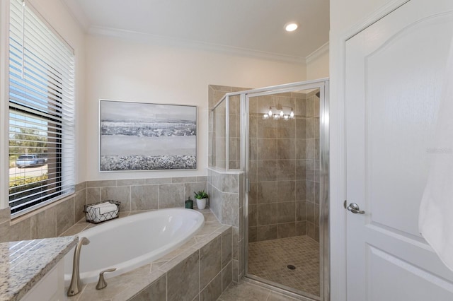 bathroom featuring crown molding, a shower stall, and a bath