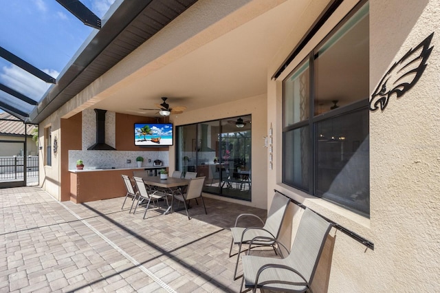 view of patio / terrace with a lanai, outdoor dining area, and a ceiling fan