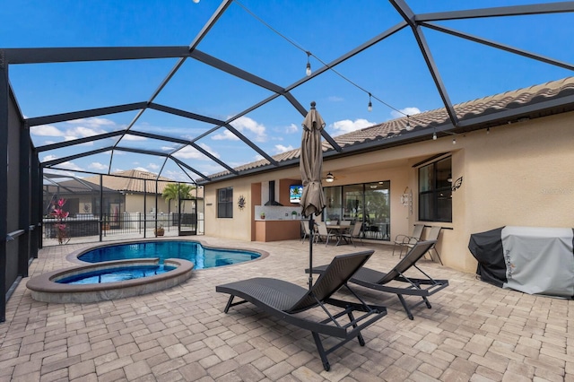 view of swimming pool with a pool with connected hot tub, a patio, area for grilling, and a lanai