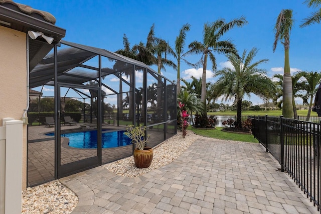 view of pool featuring a patio area, a fenced backyard, a fenced in pool, and a lanai