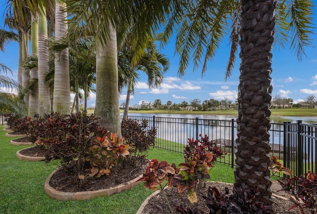 view of yard with a water view and fence