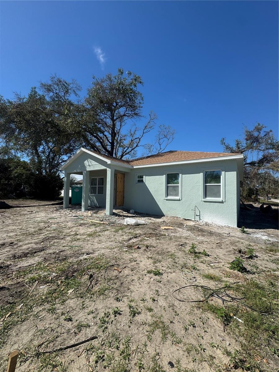 back of property featuring stucco siding