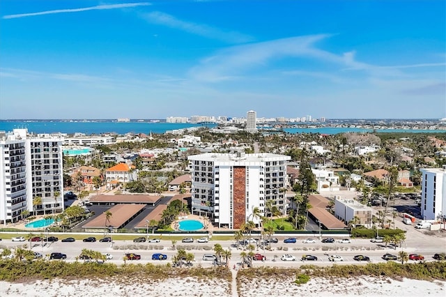 drone / aerial view featuring a water view and a view of city