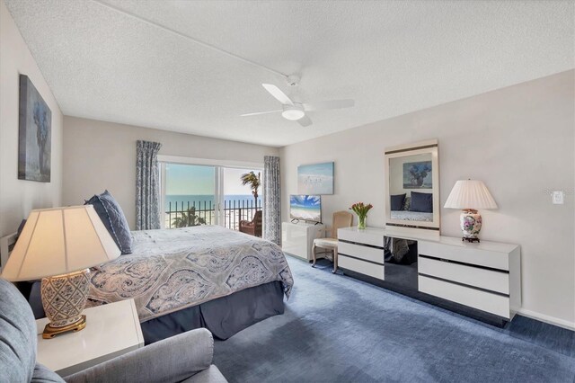 bedroom with ceiling fan, a water view, carpet floors, a textured ceiling, and access to outside