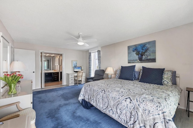 bedroom featuring a textured ceiling, ensuite bath, and ceiling fan