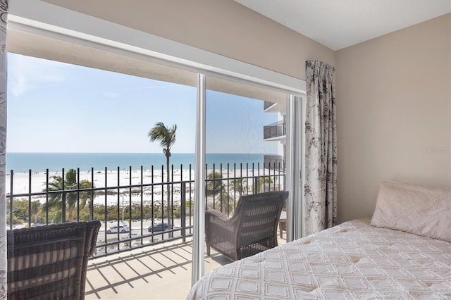 bedroom with access to exterior and a water view