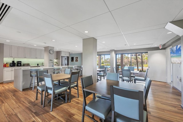 dining area with recessed lighting and light wood-style flooring