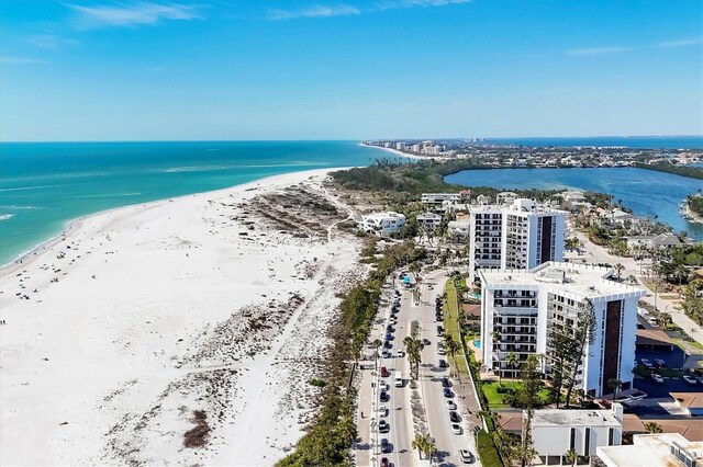 birds eye view of property with a view of the beach and a water view