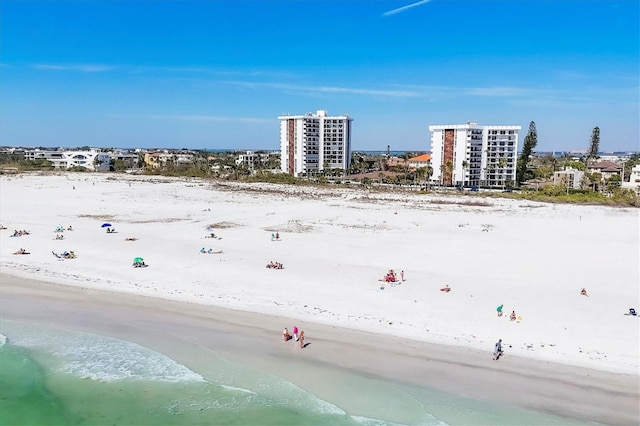 bird's eye view featuring a water view, a view of city, and a beach view
