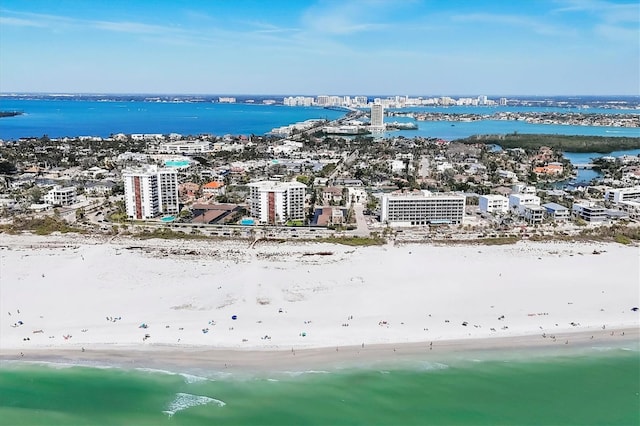 drone / aerial view with a city view, a beach view, and a water view