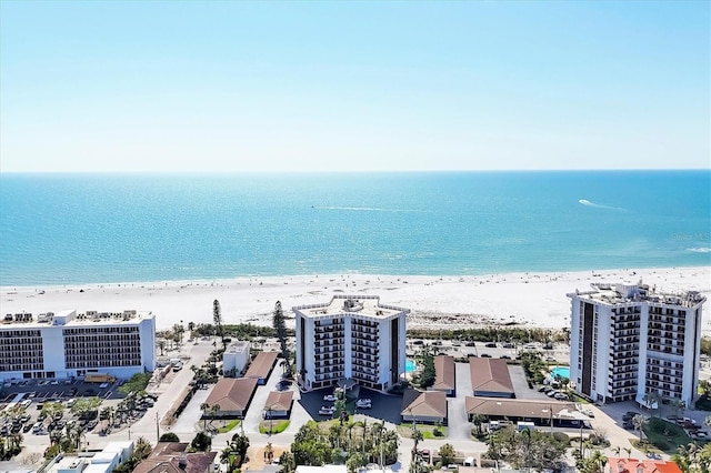 drone / aerial view with a city view, a beach view, and a water view