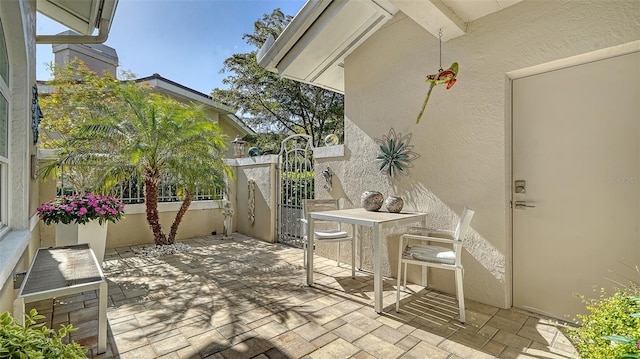 view of patio with fence and a gate