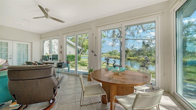 sunroom / solarium featuring french doors and ceiling fan