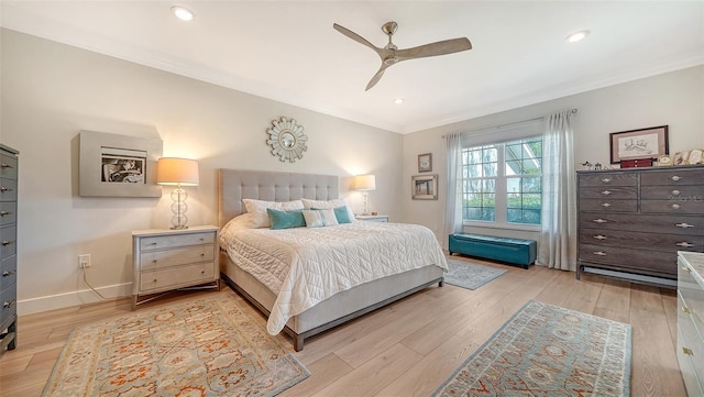 bedroom with ornamental molding, baseboards, and light wood finished floors