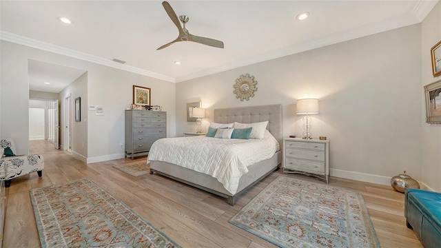 bedroom with baseboards, visible vents, and wood finished floors