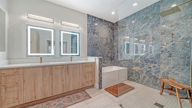 full bathroom featuring double vanity, walk in shower, a sink, and tile patterned floors