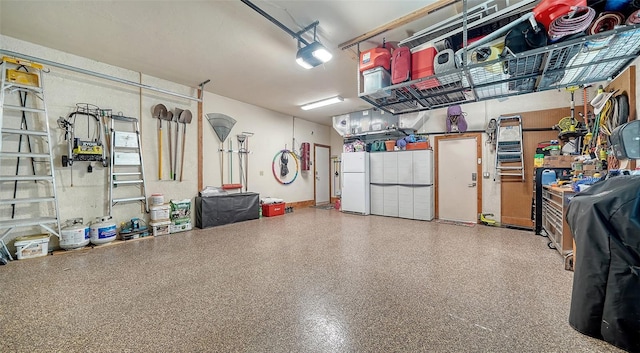 garage featuring a garage door opener and freestanding refrigerator