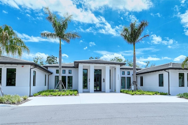 view of front of property featuring french doors and stucco siding