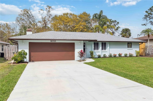 ranch-style house with an attached garage, driveway, stucco siding, a chimney, and a front yard