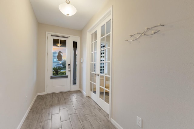 entryway with light wood finished floors and baseboards