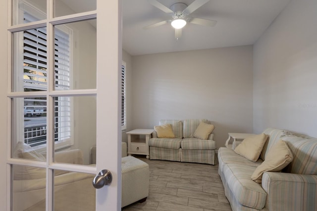 living room featuring ceiling fan and wood finished floors