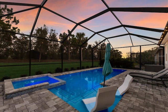 pool at dusk featuring a patio area, a pool with connected hot tub, and glass enclosure