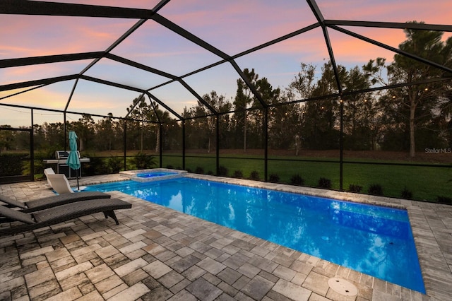 view of swimming pool with a patio, a lawn, a lanai, and a pool with connected hot tub