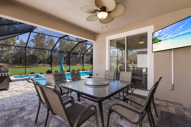 view of patio / terrace with an outdoor pool, a ceiling fan, a lanai, a grill, and outdoor dining area