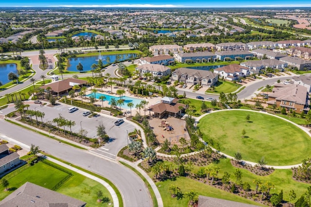 drone / aerial view with a water view and a residential view