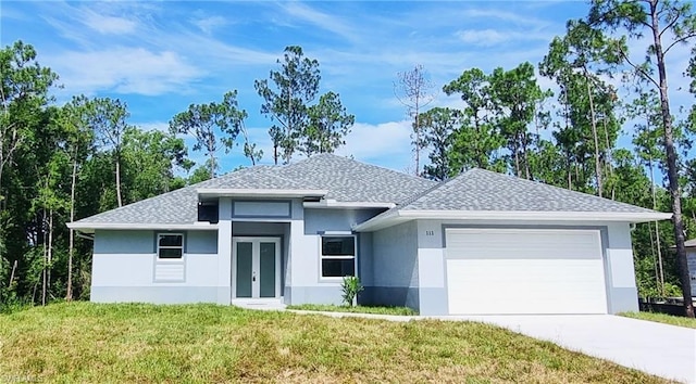 view of front facade featuring a garage, a shingled roof, driveway, french doors, and a front lawn