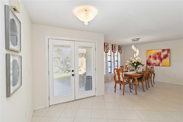 dining space with light tile patterned floors and french doors