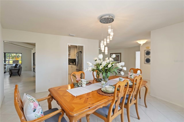 dining space featuring light tile patterned floors