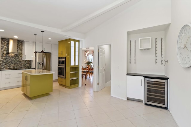 kitchen with wine cooler, vaulted ceiling with beams, backsplash, appliances with stainless steel finishes, and wall chimney range hood