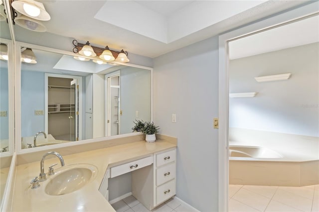 bathroom featuring a garden tub, tile patterned flooring, and vanity