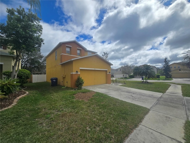 view of property exterior with concrete driveway, a lawn, and stucco siding