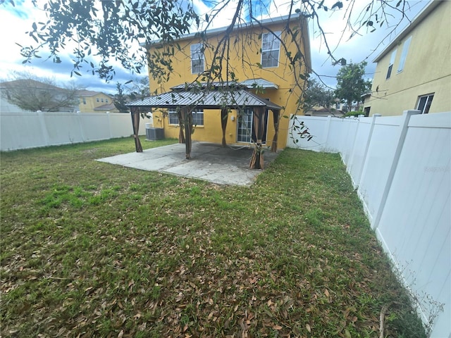 view of yard featuring a patio area, a fenced backyard, and central AC