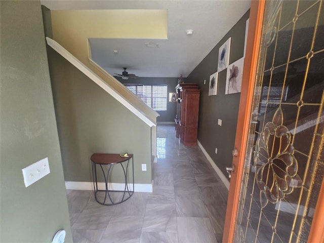 hallway with visible vents and baseboards