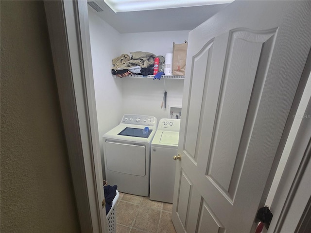 laundry room featuring laundry area, washer and clothes dryer, and visible vents