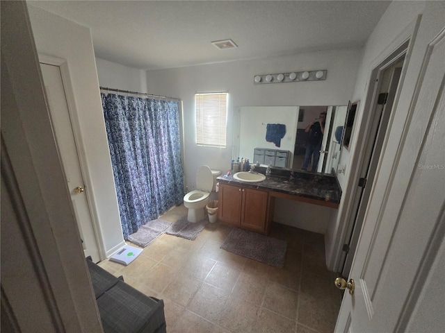 full bath featuring visible vents, vanity, and toilet