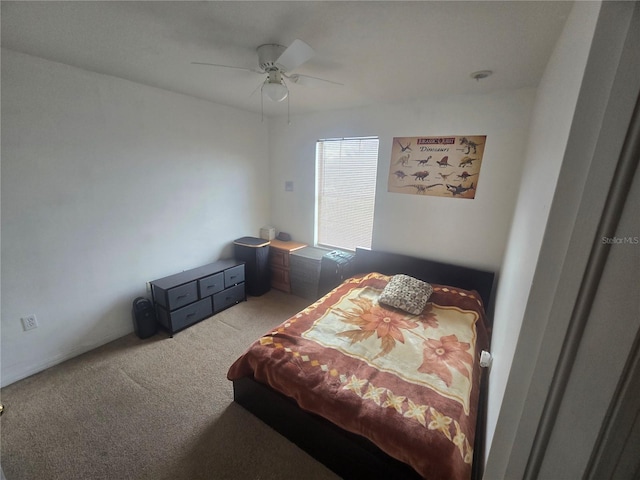 bedroom with a ceiling fan and carpet flooring