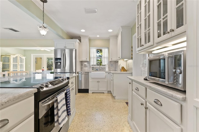 kitchen featuring stainless steel appliances, white cabinets, visible vents, and a sink