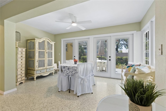 sunroom / solarium with a ceiling fan and french doors