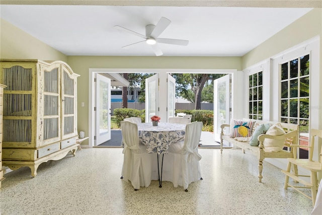 sunroom / solarium featuring a ceiling fan