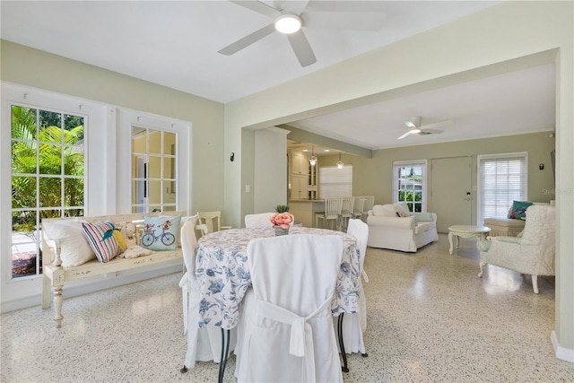 sunroom / solarium featuring a ceiling fan and french doors